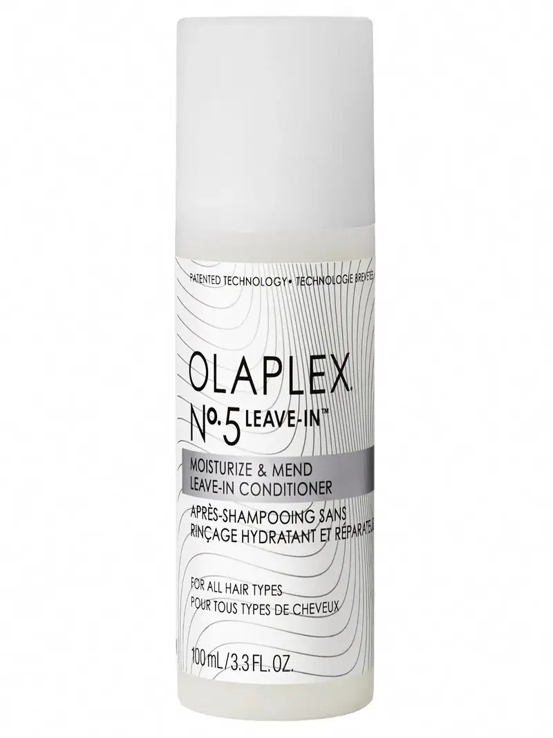 Flacon blanc Olaplex N°5 Leave-In, soin réparateur sans rinçage pour cheveux abîmés. Technologie Bond Building pour une hydratation intense et une protection thermique. Résultats visibles dès la première utilisation